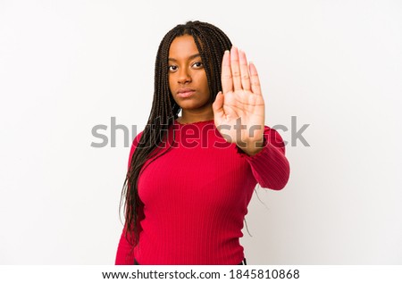 Young african american woman isolated standing with outstretched hand showing stop sign, preventing you.