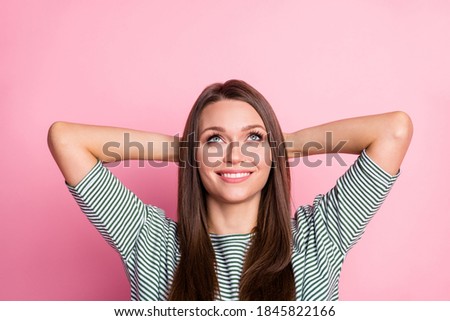 Photo of girl hands behind head white smile look empty space wear striped shirt isolated pastel pink color background