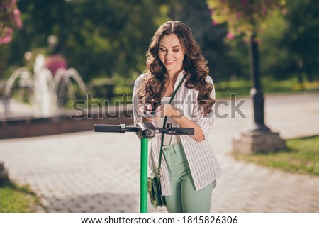 Photo of lovely healthy sporty cheery girl want ride segway scan code by telephone enjoy summer fresh air outdoor