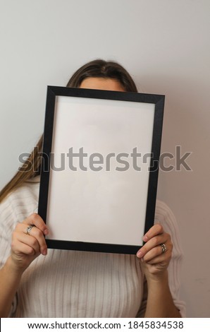 woman holding black photo frame with white background