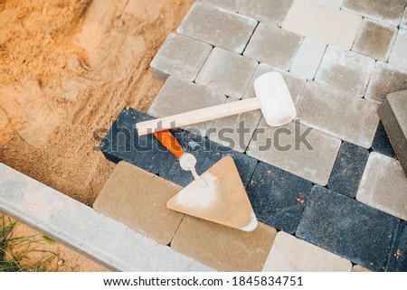Tools at the construction site for laying paving slabs - stone block paving stones for cement mortar