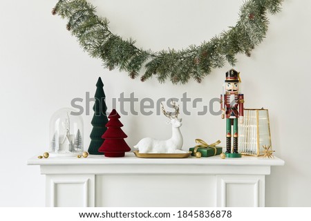 Christmas composition on the white chimney at the living room interior with beautiful decoration. Christmas tree and wreath, candles, stars, light. Copy space.  Template.
