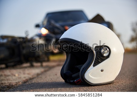 Photo of car, helmet and motorcycle on road, the concept of road accidents. Royalty-Free Stock Photo #1845851284