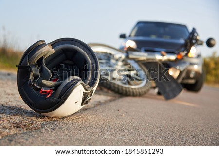 Photo of car, helmet and motorcycle on road, the concept of road accidents. Royalty-Free Stock Photo #1845851293