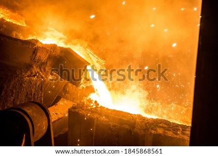 Tank pours liquid metal in the molds at the steel mill Royalty-Free Stock Photo #1845868561