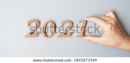 Businessman hand change wooden number 2020 to 2021 in grey color background. Plan, finance, Resolution, strategy, solution, goal, business and New Year holiday concepts