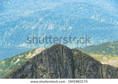 Panoramic view of mountain ranges. Rock ridge with various peaks for rock climbing