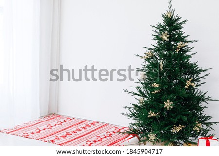 Christmas tree pine with gifts for the new year of the white room 2021 2022