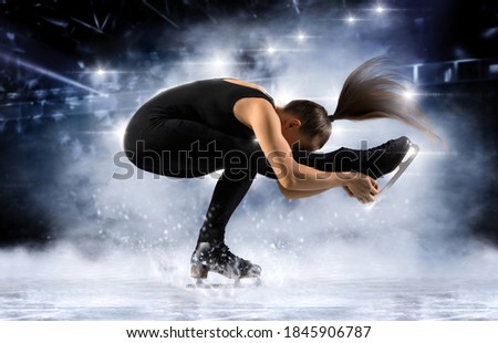 Sit spin. Woman figure skating in action on dark background. Sports banner. Horizontal copy space background