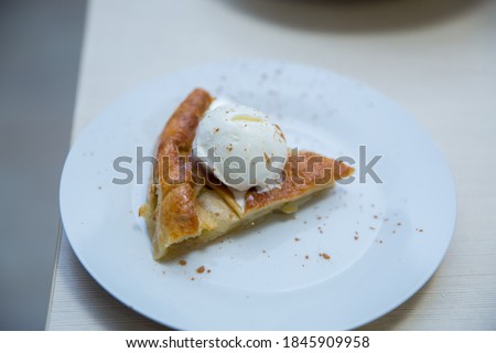
Dessert serving - apple pie with vanilla ice cream.