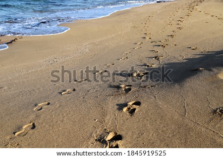 footprints in the sand by the Mediterranean Sea