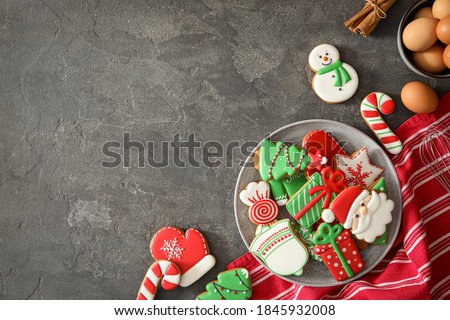 Flat lay composition with delicious homemade Christmas cookies on grey table. Space for text