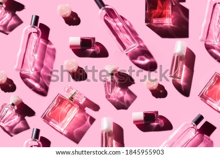 Pattern different bottles of woman perfume on a pastel pink background, top view, flat lay. Mockup of pink fragrance perfume bottle mockup on pastel pink empty background Royalty-Free Stock Photo #1845955903