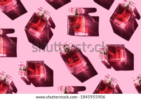 Pattern bottles of woman perfume on a pastel pink background, top view, flat lay. Mockup of pink fragrance perfume bottle mockup on pastel pink empty background Royalty-Free Stock Photo #1845955906