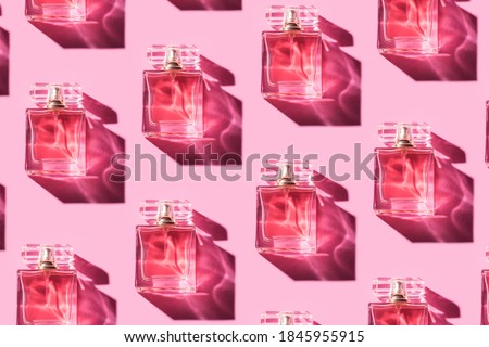 Pattern bottles of woman perfume on a pastel pink background, top view, flat lay. Mockup of pink fragrance perfume bottle mockup on pastel pink empty background Royalty-Free Stock Photo #1845955915