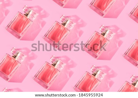Pattern bottles of woman perfume on a pastel pink background, top view, flat lay. Mockup of pink fragrance perfume bottle mockup on pastel pink empty background Royalty-Free Stock Photo #1845955924