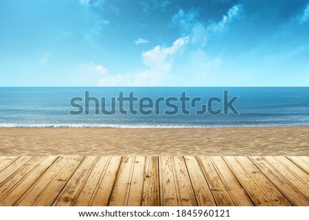 View of a beach with wooden floor and the sea in the background on a summer day Royalty-Free Stock Photo #1845960121