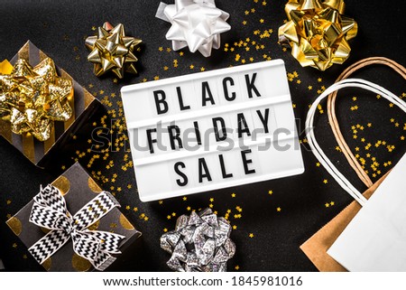 Black friday sale concept with present boxes at black background. Online shopping. Top view.