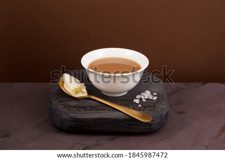 Yak Butter Tea, known as "Po Cha", a traditional Tibetan drink made if Yak butter and salt. Close-up, selective focus, copy space. Royalty-Free Stock Photo #1845987472