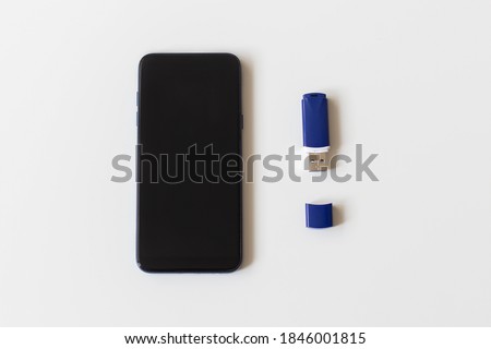 the phone and flash drive on a white background