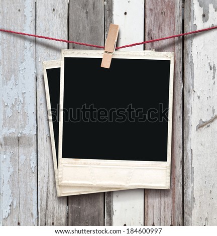  two  photos hanging on wooden background.