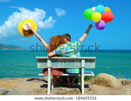 Young couple enjoying honeymoon on a calm and peaceful relaxing in front of the ocean view.