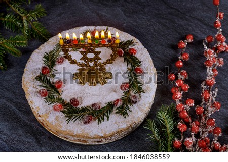 Hanukkah cake with burning menorah on the top.