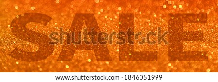 Sale banner orange festive shimmery luxury shining large letters, texture glowing .Popular autumn sale shopping day 11.11, black friday, cyber monday . New Year and Christmas holiday sale concept.