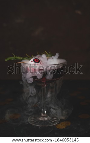 Halloween cocktail with eye and fog