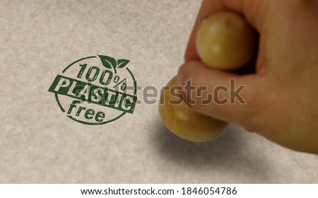 Plastic free 100% stamp and stamping hand. Ecology, nature, eco friendly, climate change, green technology and earth safe concept.