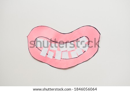 Kid construction paper craft smiling mouth and teeth white background