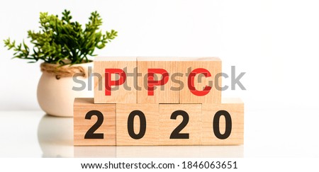 PPC 2020 - Pay-Per-Click - word written on wood block. search engine optimization, Faqs text on table, concept. Red letter PPC.