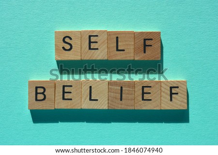 Self Belief, words in wooden alphabet letters isolated on plain background