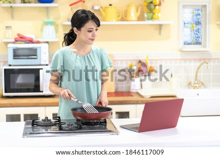 Asian woman cooking in the kitchen