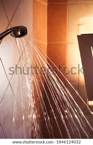 Water flowing from shower faucet in the bathroom - Close up