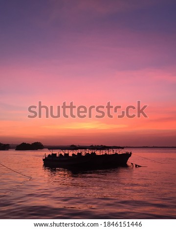 The beautiful silhouette of a broken boat on the beach of Tanjung Benoa