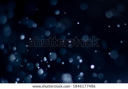 Photo of bokeh design light style new blue theme or cool color abstract pattern blurred background used in Christmas and New Year or celebration.