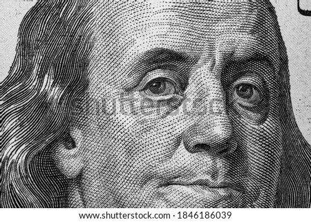 United States hundred dollars money bill closeup. Portrait of US president Benjamin Franklin on 100 dollars banknote macro fragment
