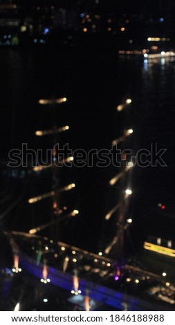 Blur bokeh picture of a lights of the sail boat near Chaopraya River in Loy Kratong festival night in Bangkok Thailand with blank empty copy space of dark sky for text or quote