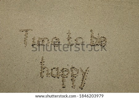 time to be happy, happiness concept. The sign written on sand