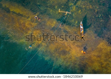 Aerial view of  fish farm and fisherman near Ong Cop or Mr Tiger wooden bridge at Tuy An, Phu Yen, Vietnam.