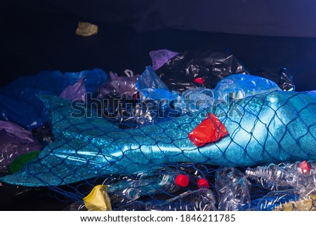 Ocean plastic pollution concept. Close-up of Mermaid, polluted habitat