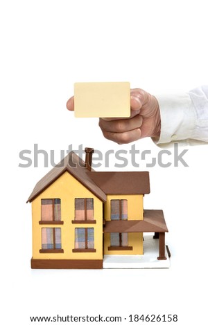 Real estate concept. hand holding blank card at miniature house