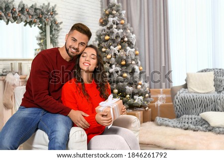 Lovely couple celebrating Christmas together at home