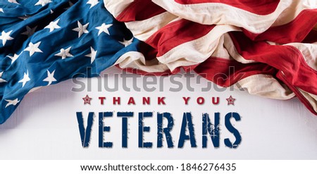 Happy Veterans Day concept. American flags against white wooden  background. November 11. Day