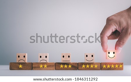 customer services best excellent business rating experience. Satisfaction survey concept. Hand of a businessman chooses a smiley face on wood block cube. 5 Star Satisfaction. Royalty-Free Stock Photo #1846311292