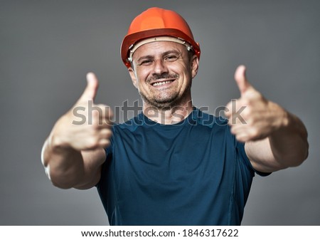 Engineer in hard hat making thumbs up sign
