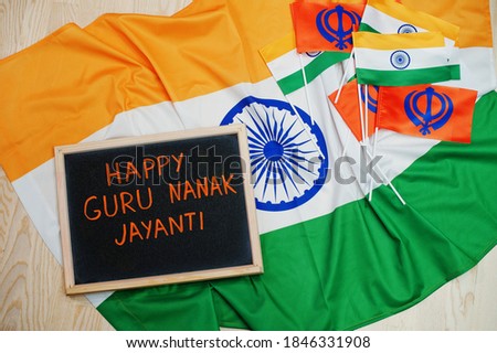 Happy Guru Nanak Jayanti theme. Board with flags.