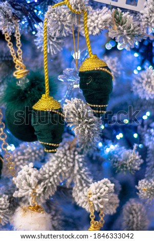 Green christmas toys on blue christmas tree