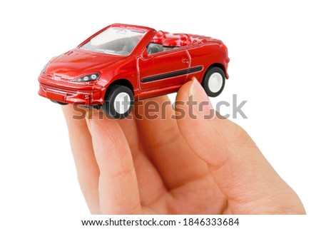 Hand and toy car isolated on white background